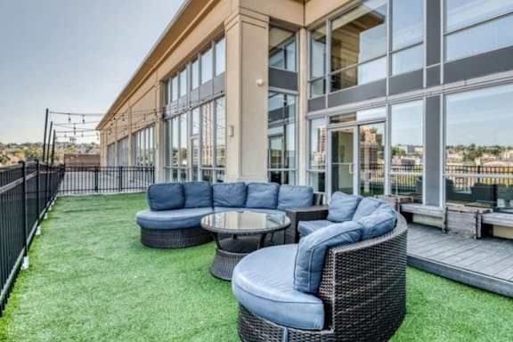 A patio area with a table and chairs.at 66 Main, New York, 10701