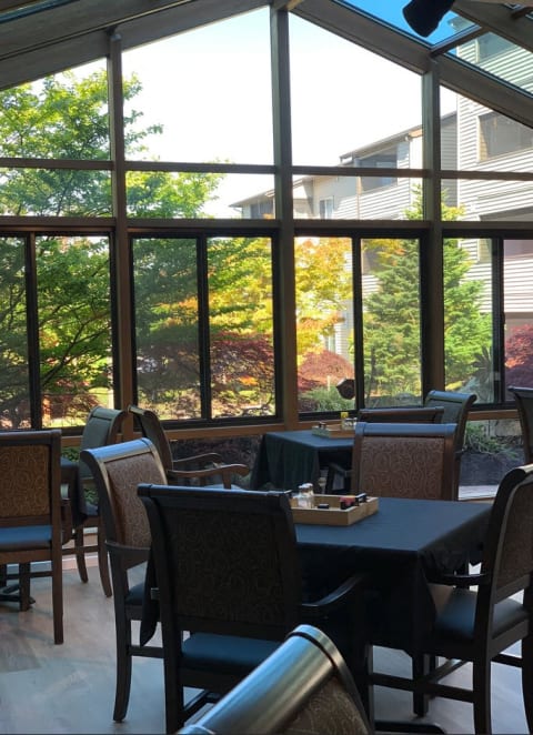 a dining room with large windows and tables