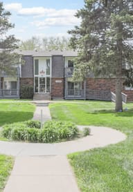 A building with a green lawn in front of it.