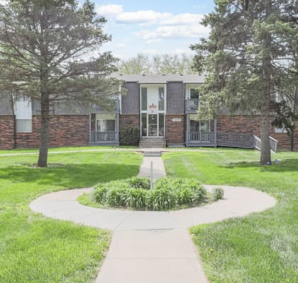 A building with a green lawn in front of it.