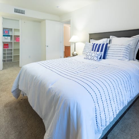 a bedroom with a bed and a dresser and a window