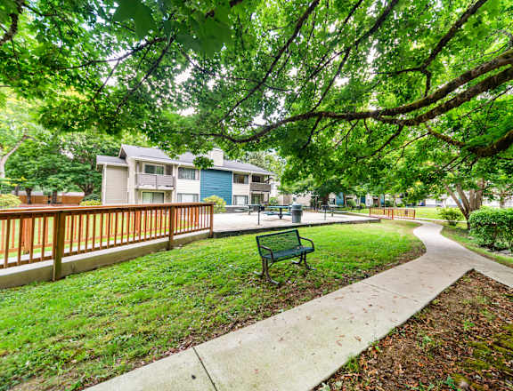 A park with a bench and a pathway.