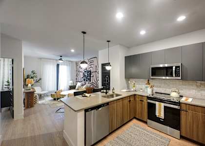 A modern kitchen with a large island and stainless steel appliances.