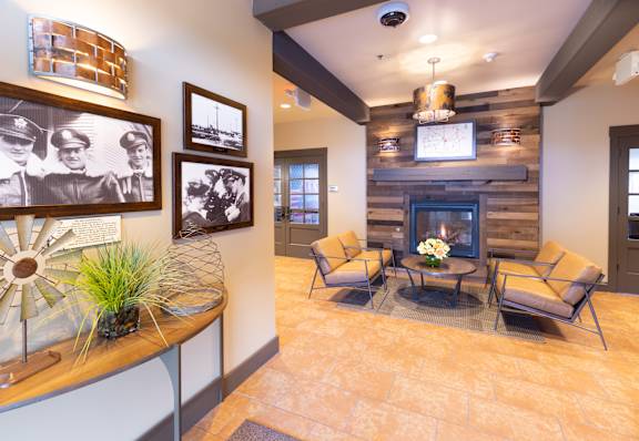 A living room with a fireplace and a tv above it.
