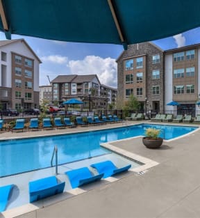 Swimming pool at Berewick Pointe Apartments has a sundeck with lounge chairs.