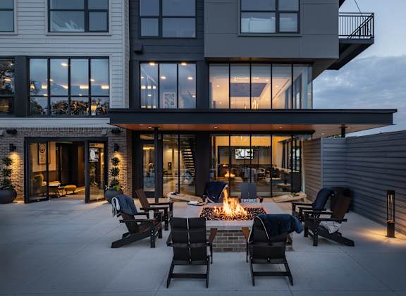 A modern house with a patio and a fire pit.