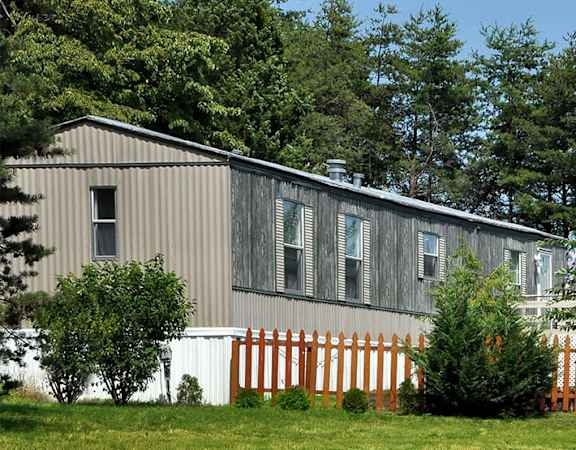 a house with a wooden fence in front of it