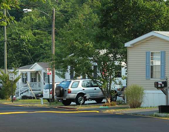 a couple of cars parked in front of a house