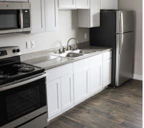 a kitchen with stainless steel appliances and white cabinets at Trails Corner Apartments, Raleigh, NC, 27610