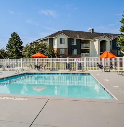 our apartments have a resort style pool with chairs and umbrellas