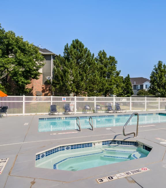 our apartments have a resort style pool with chairs and a fence