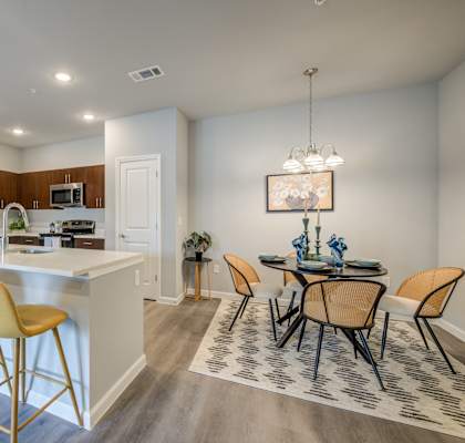 an open kitchen and dining area with a dining table and chairs