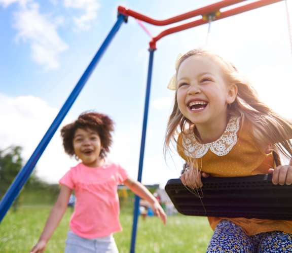 Girls playing on swing set