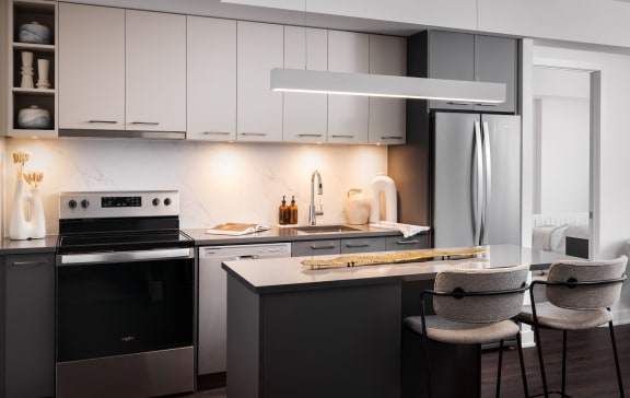 a kitchen with white cabinets and a table with chairs
