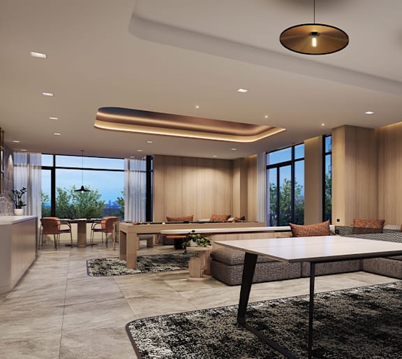 A modern living room with a large table and comfortable seating.