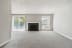 an empty living room with a fireplace