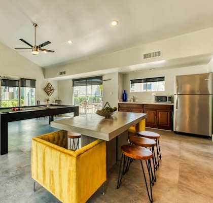 A modern kitchen with a dining table and chairs. at Connect on Northern Apartments, Glendale 85301