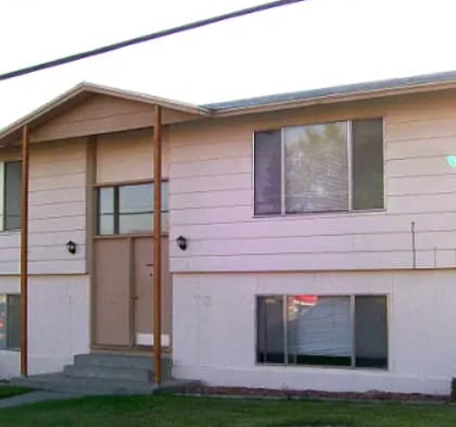 A house with a brown door and windows.