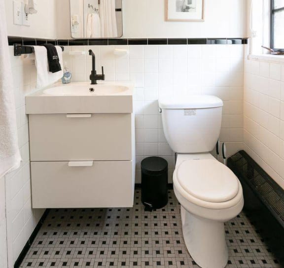 a bedroom with a bed and a door to a bathroom