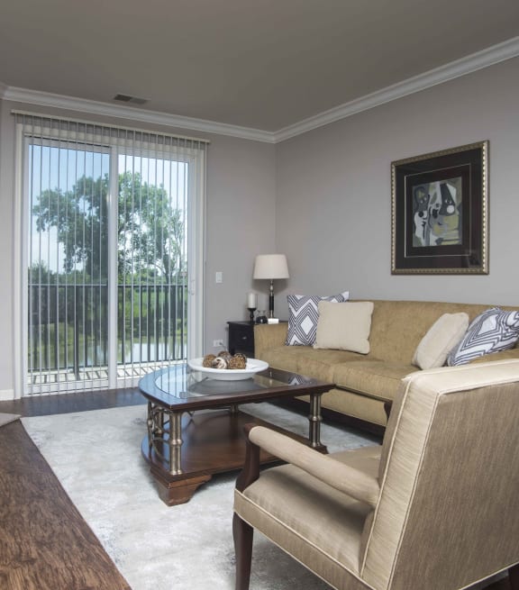 a living room with a couch coffee table and fireplace at The Sanctuary of Lake Villa, Lake Villa, IL