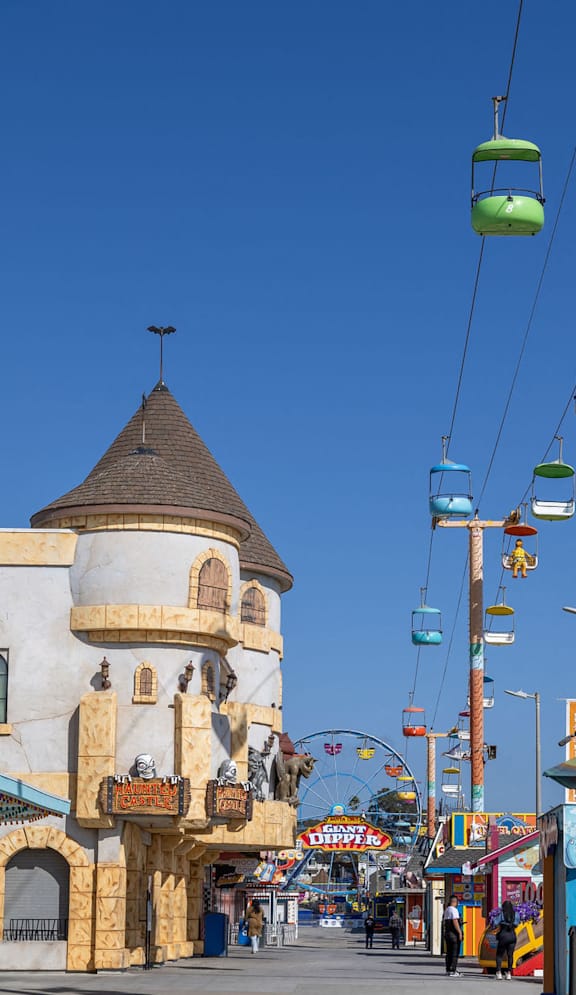 a city street with a tower and a ferris wheel