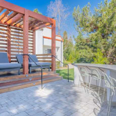 a patio with chairs and a table and a wooden deck at The Resort at Encinitas Luxury Apartment Homes, Encinitas, 92024