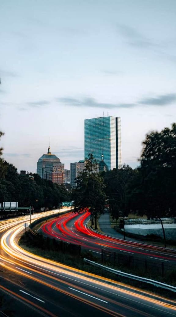 a busy highway with a city in the background