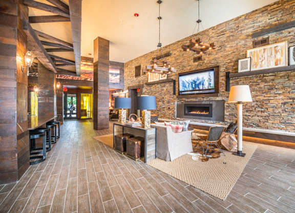 Lounge Area With Stone Fireplace at Aviator West 7th, Fort Worth