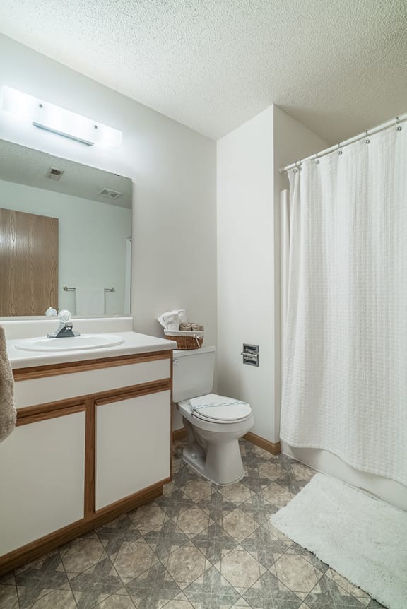 Bathroom with bright lighting and vanity at The Northbrook Apartment Homes, Lincoln, NE