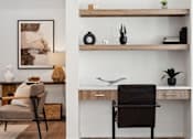 Thumbnail 9 of 51 - A modern home office with a chair, desk, and shelves.