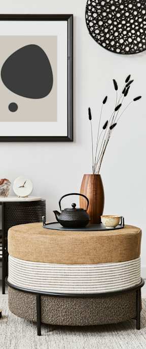 A round table with a striped cloth on it.