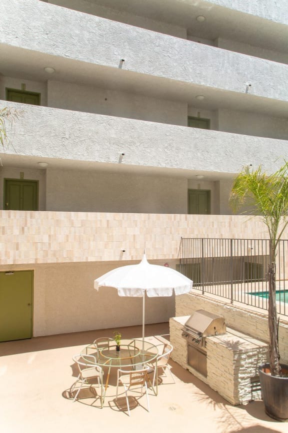 a patio with a table and chairs and an umbrella