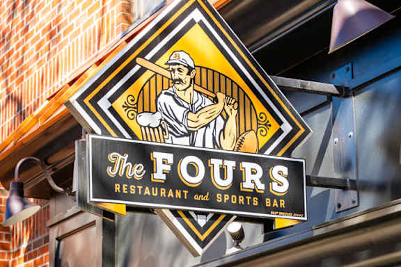 A sign for The Fours Restaurant and Sports Bar.