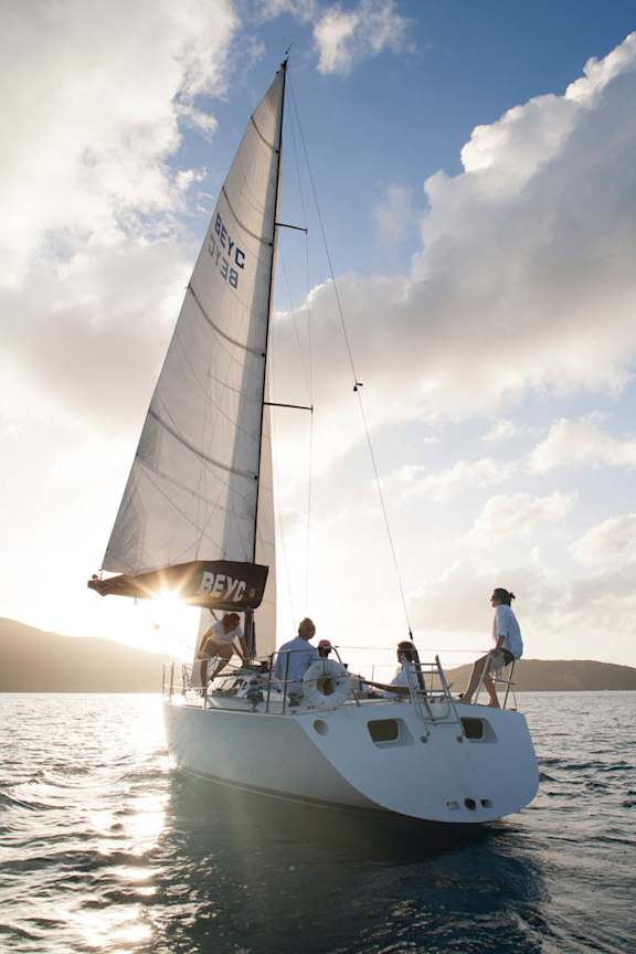 a group of people on a sail boat in the ocean