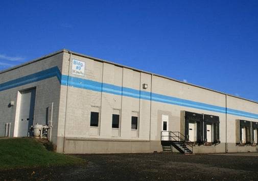 a large white building with a blue stripe on it