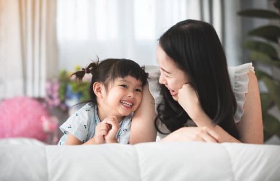 Mother and daughter smiling
