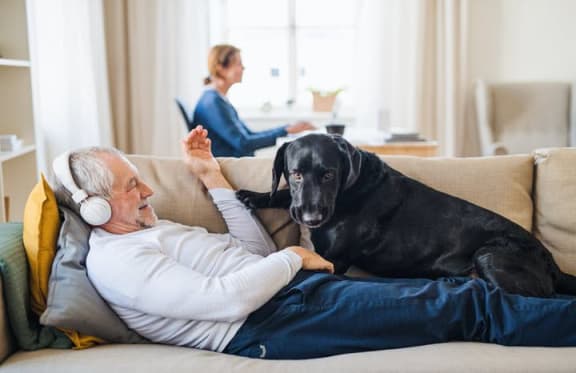 Man on sofa with dog