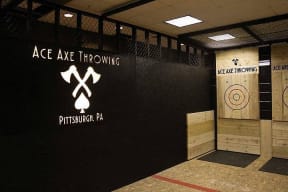 a black wall with logos on it in a building