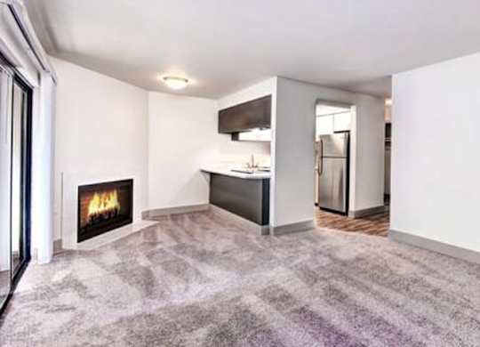 Milton Apartments - Autumn Village Apartments - Living Room, Fireplace, Kitchen, and Deck