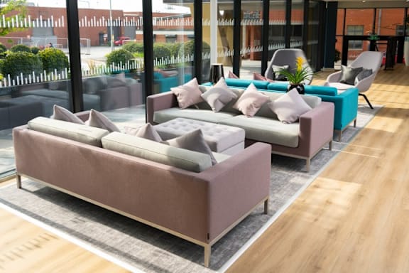 a seating area with couches and chairs in a lobby at The Trilogy Apartments, Manchester, M15 4RU
