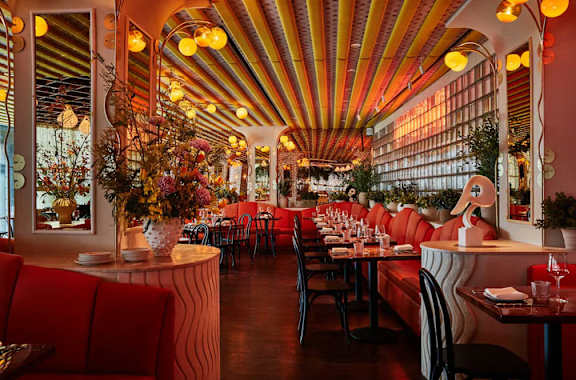 A restaurant with red booths at MARC Apartments, New York, NY