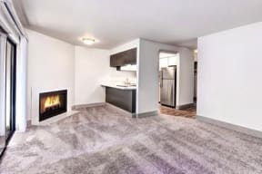 Milton Apartments - Autumn Village Apartments - Living Room, Fireplace, Kitchen, and Deck