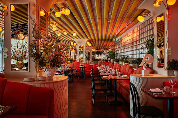 A restaurant with red booths at MARC Apartments, New York, NY