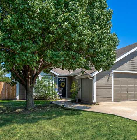 A house with a tree in front of it.