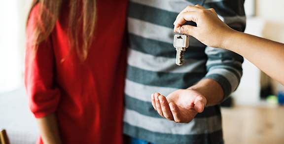 a person handing a key to another person