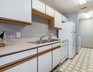 kitchen with laundry room off to side at Williamsburg Park Apartments in Lincoln NE