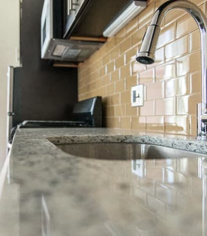 a kitchen with a sink and a microwave