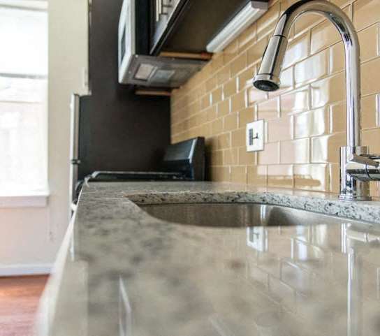 a kitchen with a sink and a microwave