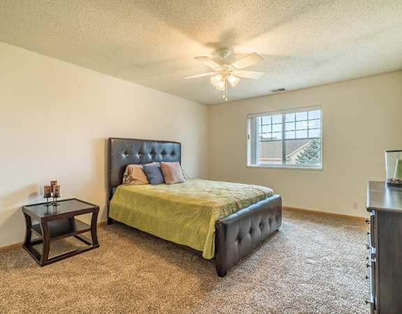 Bedroom with ceiling fan at The Northbrook Apartment Homes, Lincoln, NE