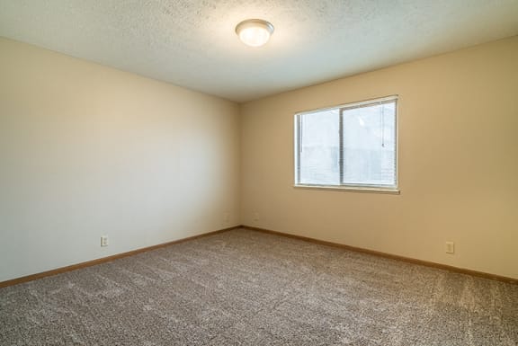 Large bedroom with natural light at Fountain Glen Apartments